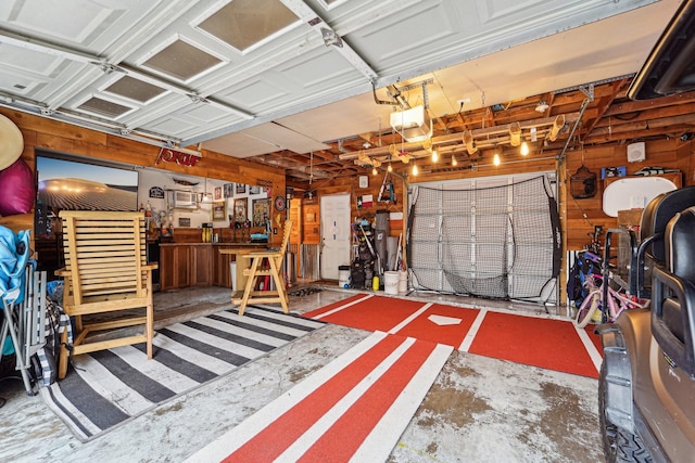 garage with a garage door opener and a workshop area