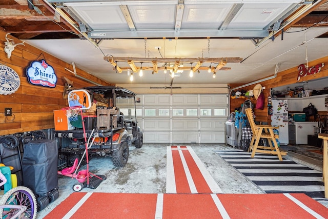 garage featuring a garage door opener and wooden walls