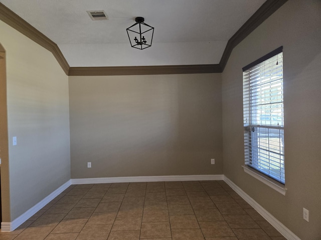 unfurnished room with tile patterned flooring, ornamental molding, a healthy amount of sunlight, and lofted ceiling