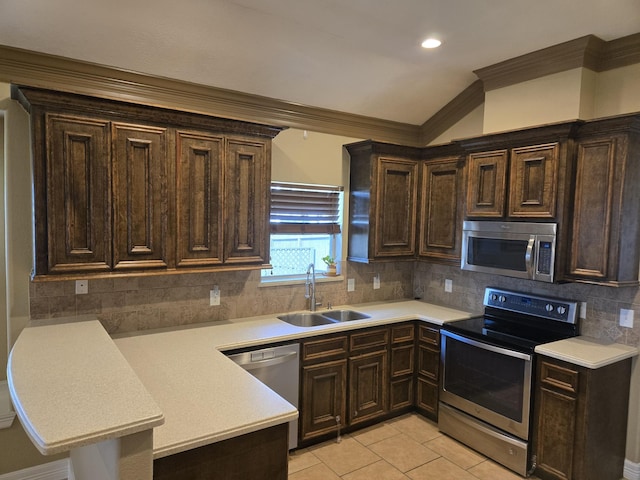 kitchen featuring sink, crown molding, light tile patterned floors, stainless steel appliances, and decorative backsplash