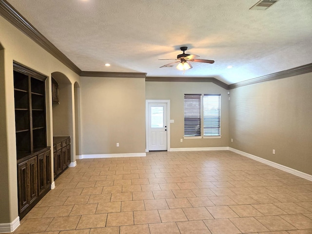 interior space featuring lofted ceiling, light tile patterned floors, ceiling fan, ornamental molding, and a textured ceiling