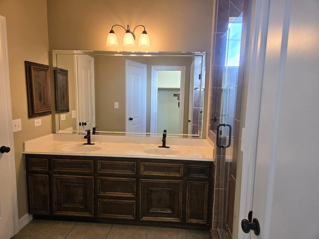 bathroom featuring tile patterned flooring, vanity, and a shower with door