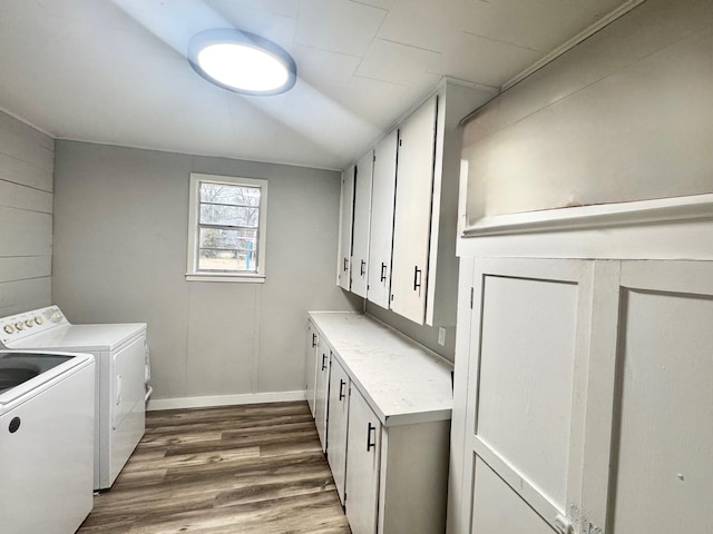 washroom with cabinets, independent washer and dryer, and dark hardwood / wood-style floors