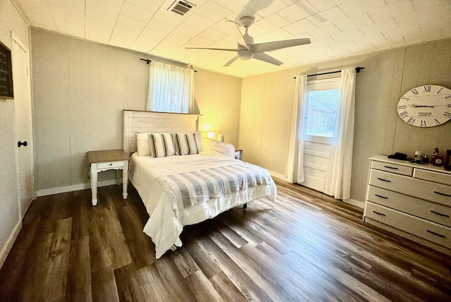 bedroom featuring ceiling fan and dark hardwood / wood-style floors