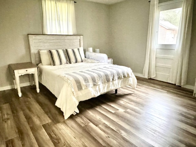 bedroom with dark wood-type flooring