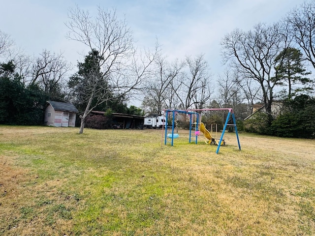 view of yard featuring a playground and a storage shed