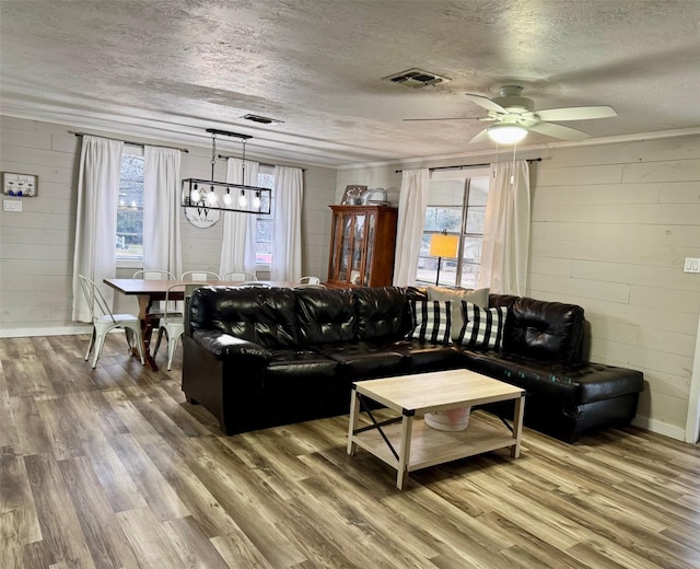 living room featuring hardwood / wood-style flooring, a wealth of natural light, and a textured ceiling