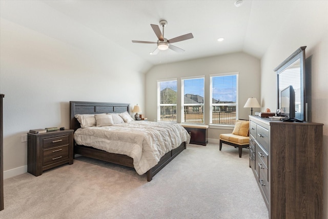 bedroom with multiple windows, lofted ceiling, and light colored carpet