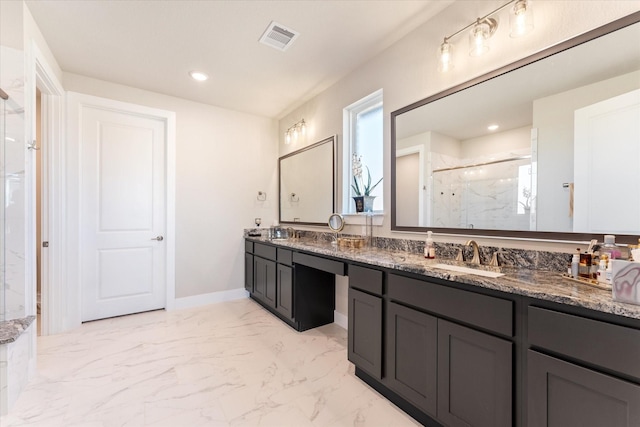 bathroom with vanity and a shower with shower door