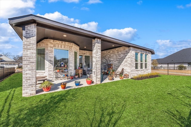 back of house featuring a yard and a patio area