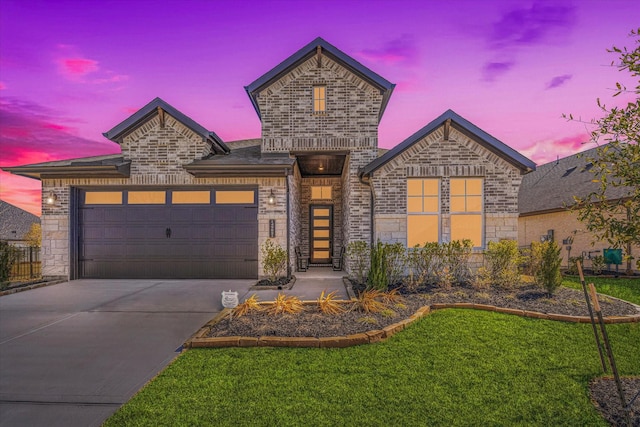 view of front of home featuring a garage and a lawn