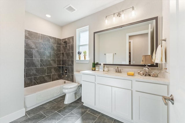 full bathroom featuring vanity, toilet, and tiled shower / bath combo