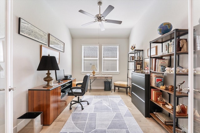 office area featuring light hardwood / wood-style flooring, vaulted ceiling, and ceiling fan