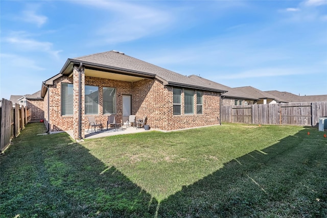 back of property featuring a yard and a patio area