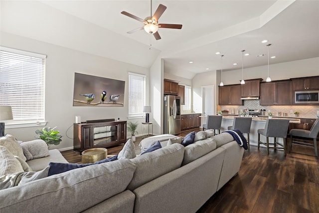 living room with dark wood-type flooring, ceiling fan, and vaulted ceiling