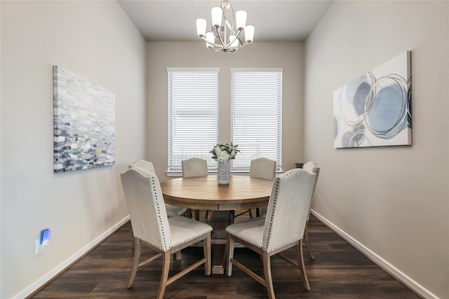 dining area with dark hardwood / wood-style floors and a chandelier