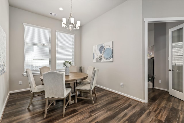 dining space with an inviting chandelier and dark hardwood / wood-style floors