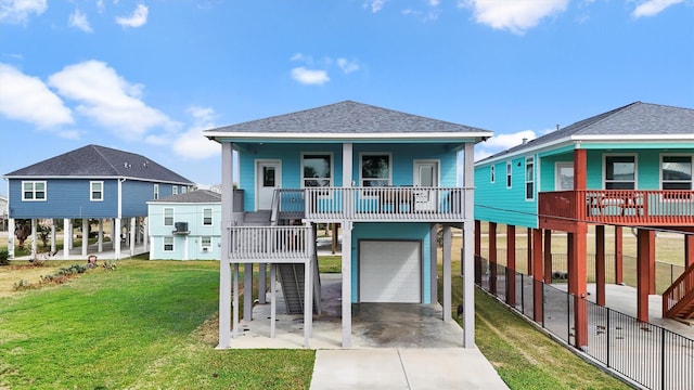 view of front of property with a garage, covered porch, and a front lawn