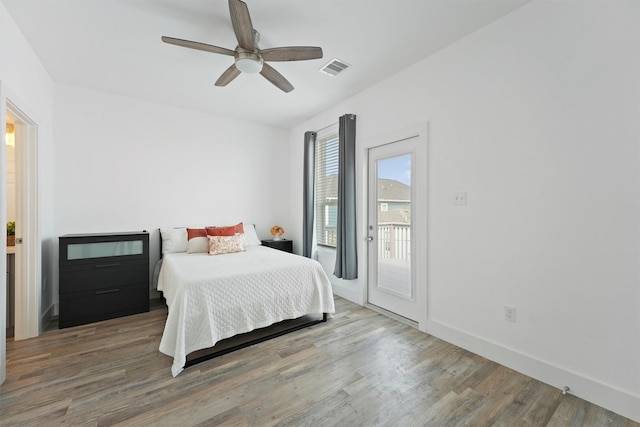 bedroom featuring hardwood / wood-style flooring, access to outside, and ceiling fan