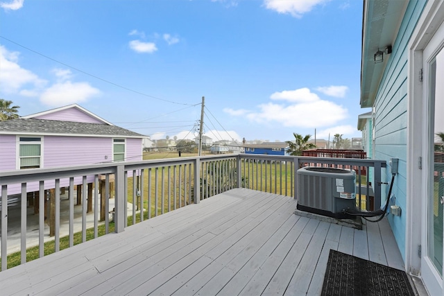 deck with central AC unit and a yard