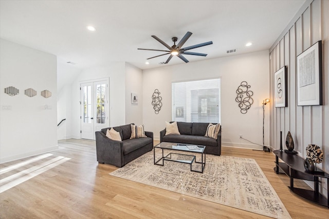 living room with french doors, ceiling fan, and light hardwood / wood-style flooring