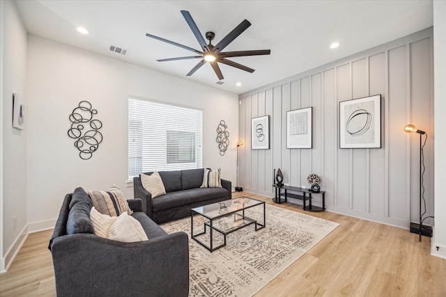 living room featuring ceiling fan and light wood-type flooring