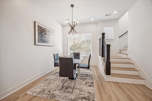 dining area with a notable chandelier and light wood-type flooring