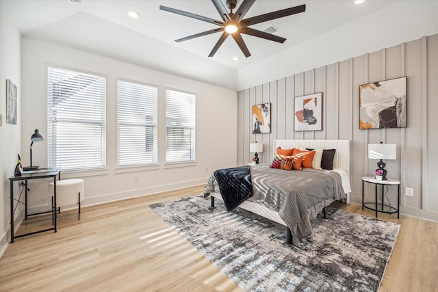 bedroom featuring ceiling fan, vaulted ceiling, and light hardwood / wood-style flooring