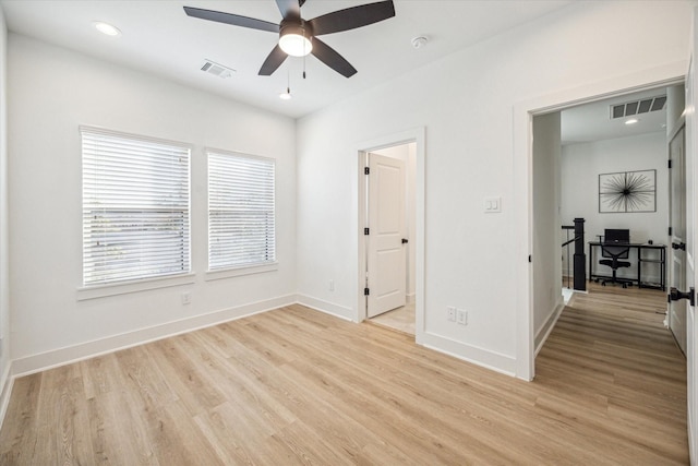 unfurnished bedroom with ceiling fan and light hardwood / wood-style floors