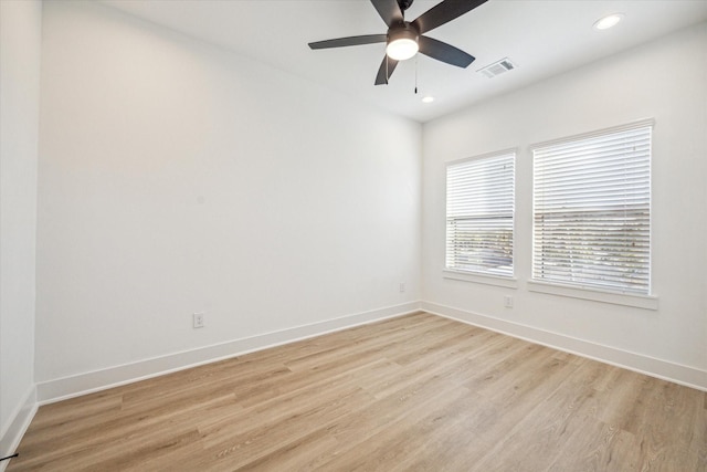 spare room with ceiling fan and light wood-type flooring