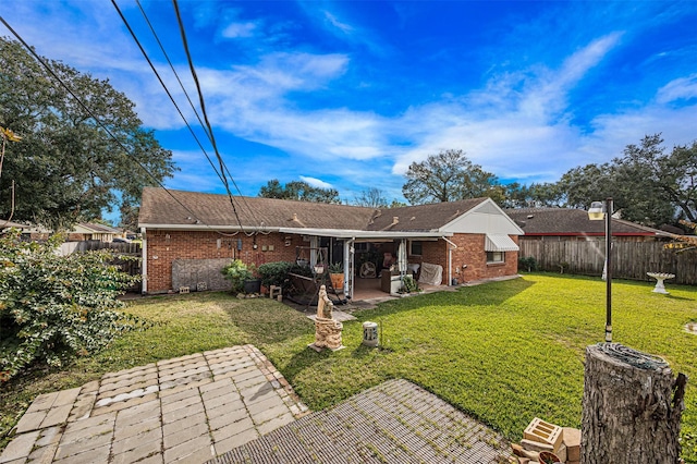 back of property featuring a patio area and a lawn