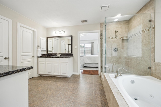 bathroom featuring vanity, shower with separate bathtub, and tile patterned floors