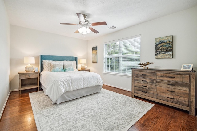 bedroom with dark hardwood / wood-style floors and ceiling fan