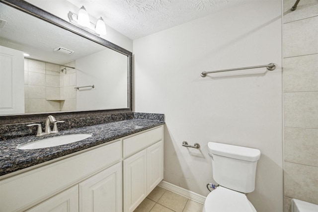 bathroom featuring tile patterned flooring, vanity, a textured ceiling, and toilet