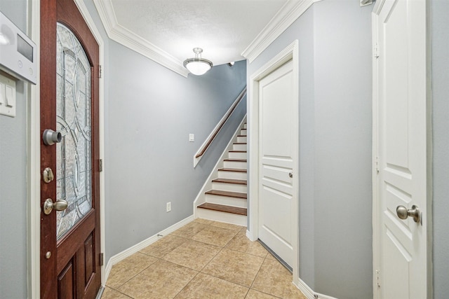 foyer entrance featuring ornamental molding and light tile patterned flooring