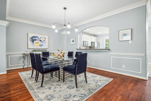 dining room featuring an inviting chandelier, crown molding, and dark wood-type flooring