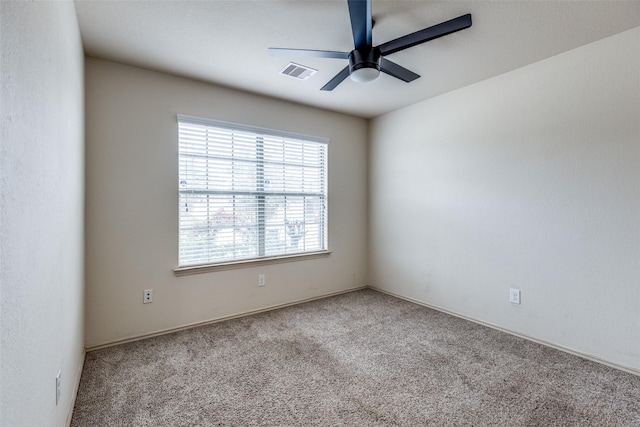 unfurnished room with carpet flooring and ceiling fan