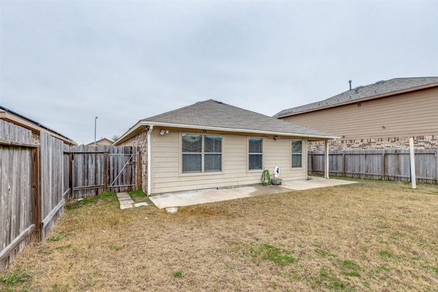 back of property featuring a patio and a yard