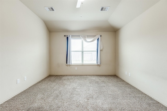 carpeted spare room featuring vaulted ceiling