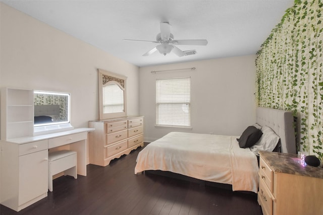 bedroom with dark hardwood / wood-style floors and ceiling fan