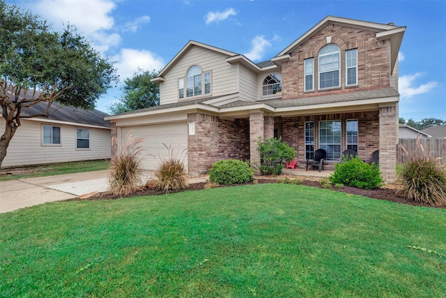 front facade featuring a garage, covered porch, and a front yard