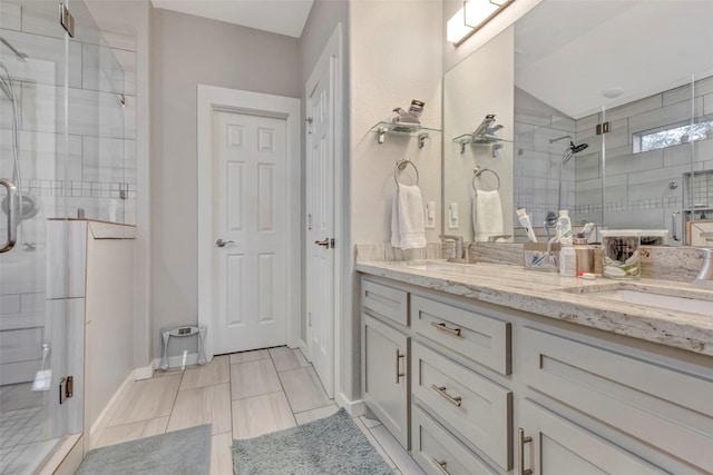 bathroom with a shower with door and vanity