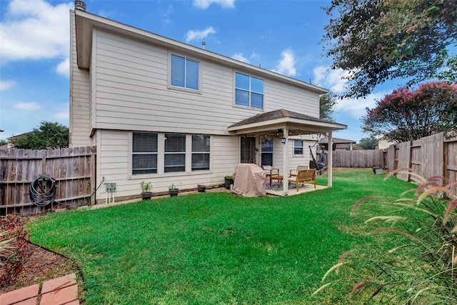 back of property featuring a yard and a patio area