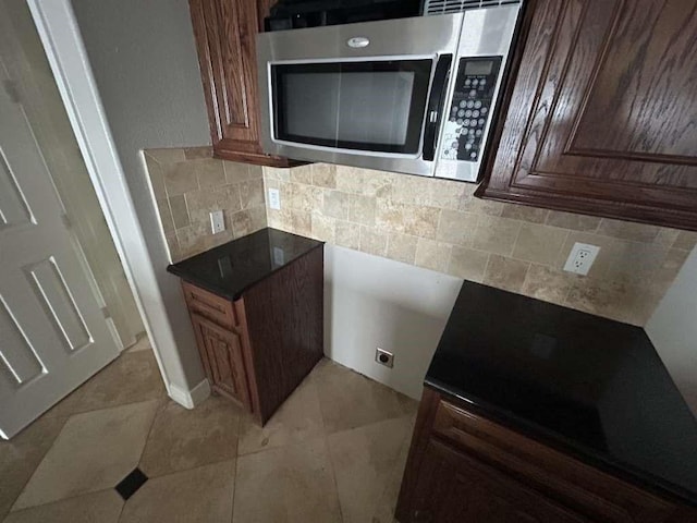 kitchen featuring light tile patterned floors and decorative backsplash