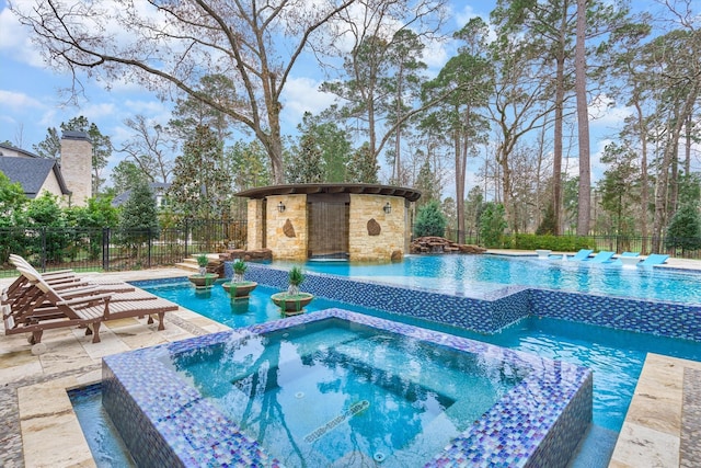 view of pool featuring an in ground hot tub and a patio