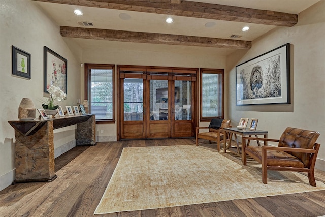 living area featuring hardwood / wood-style flooring and beamed ceiling