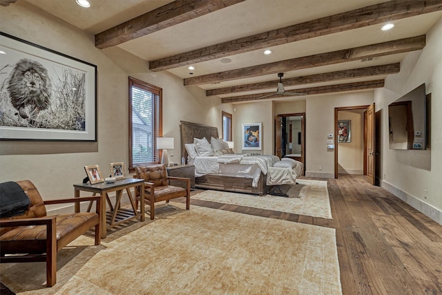 bedroom featuring hardwood / wood-style floors and beamed ceiling