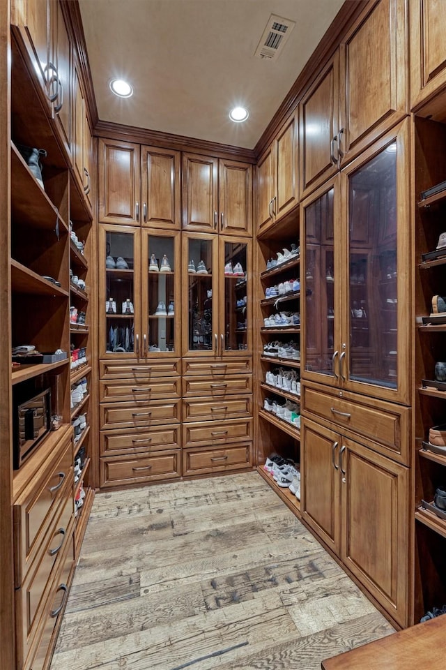 spacious closet with hardwood / wood-style floors