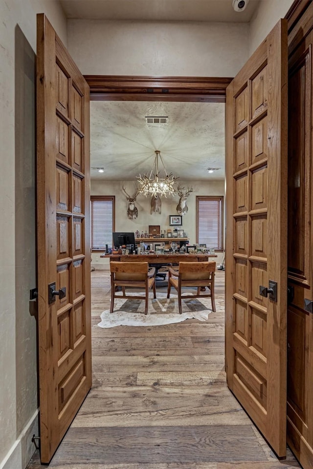 office space with wood-type flooring and a chandelier