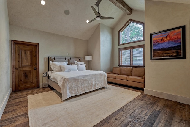 bedroom with dark wood-type flooring, ceiling fan, beam ceiling, and high vaulted ceiling